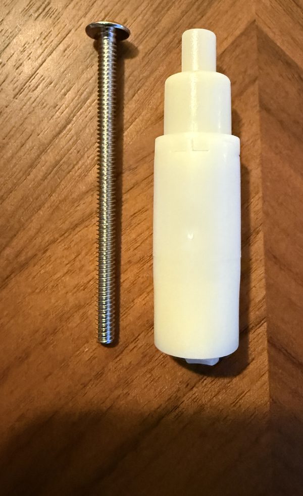 Replacement for Delta RP12631: white plastic stem extender beside its long handle screw