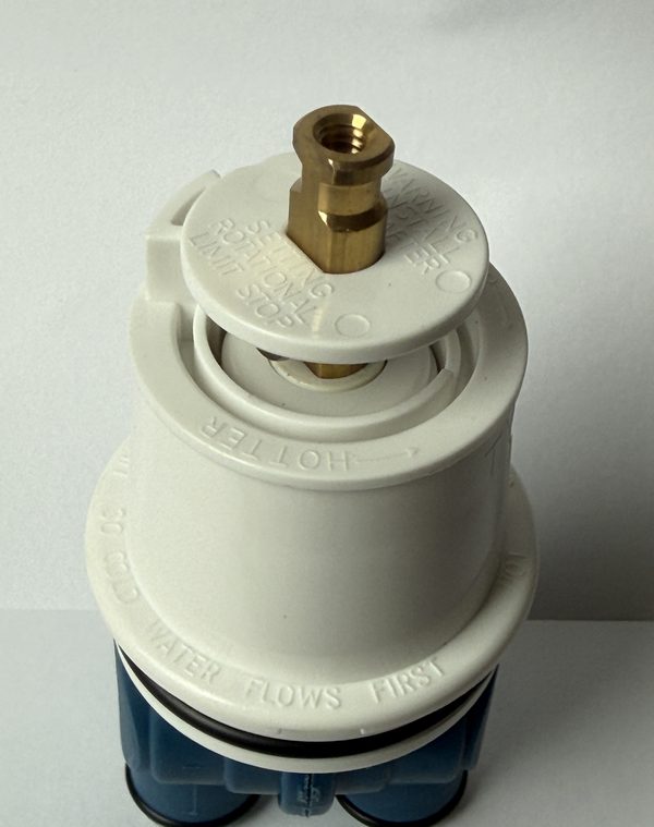Top view of the brass stem end and white cap on the replacement for Delta RP19804