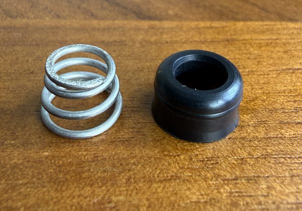Replacement for Delta RP4993 seat and spring Replacement for Delta RP4993: one black rubber seat beside one silver coil spring
