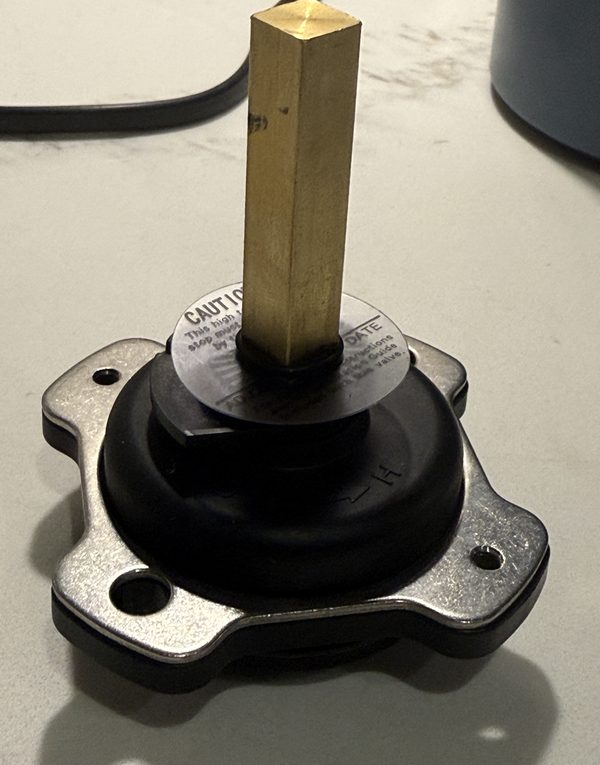 Replacement for Kohler GP77886: black mixer cap with a square brass stem on a metal retaining plate
