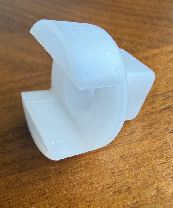 The two curved prongs of the plastic twist tool for Moen 1200 and 1225 cartridges